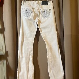 White jeans with blinged pockets on front and back.